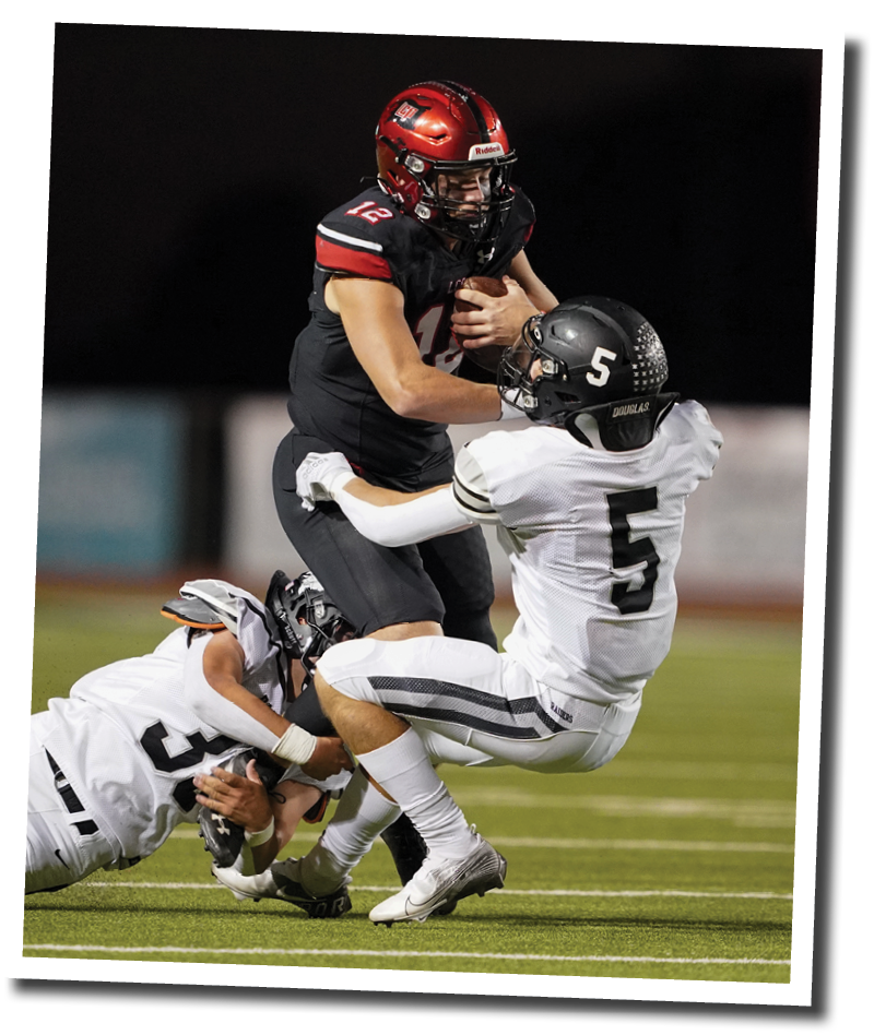 Pirate QB Holt Gibson barrels into Randall Raider Illir Haliti  Lubbock-Cooper vs  Randall  Photo by: Aaron Baxter