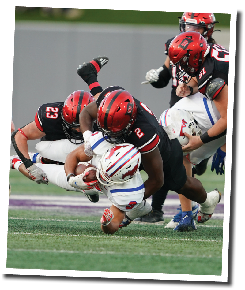 Lubbock Cooper s Kyle Lewis (23) and Kobie McKinzie (2) take down Grapevine s Caleb Texada  Lubbock-Cooper vs  Grapevine  Photo by: Aaron Baxter