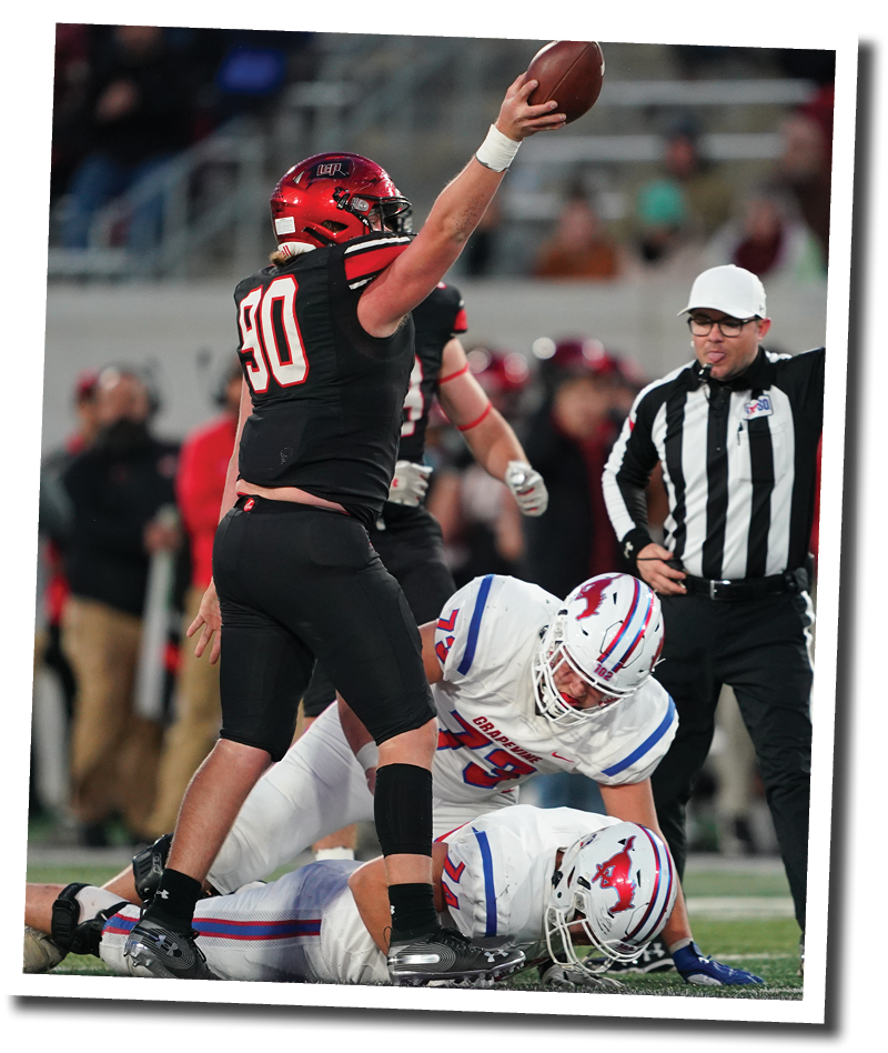 Timothy Haynes emerges with the football after Kyler Jordan forces a fumble from Grapevine s Colt Mercer  Lubbock-Cooper vs  Grapevine  Photo by: Aaron Baxter