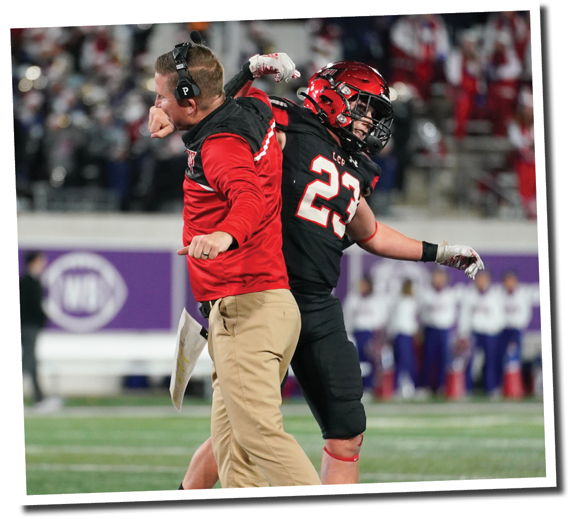 Kyle Lewis celebrates with head coach Chip Darden after the defense makes a stop on 4th down  Lubbock-Cooper vs  Grapevine  Photo by: Aaron Baxter