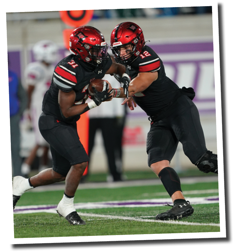 Holt Gibson (12) hands the ball off to Kaden Chambers (31)  Lubbock-Cooper vs  Grapevine  Photo by: Aaron Baxter