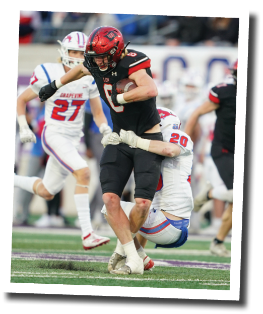 Brady Barnett drags a defender after a big gain  Lubbock-Cooper vs  Grapevine  Photo by: Aaron Baxter