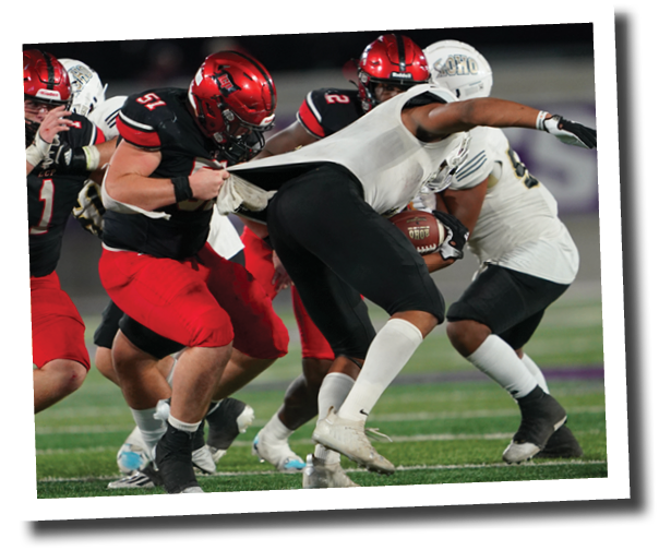 Ty Politte (51) grabs the jersey of Anquan Willis and makes the tackle  Lubbock-Cooper vs  Rider  Photo by: Aaron Baxter