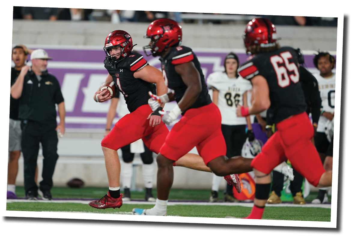 Kyler Jordan (1) intercepts a pass and runs the other way with blockers for a pick six  Lubbock-Cooper vs  Rider  Photo by: Aaron Baxter
