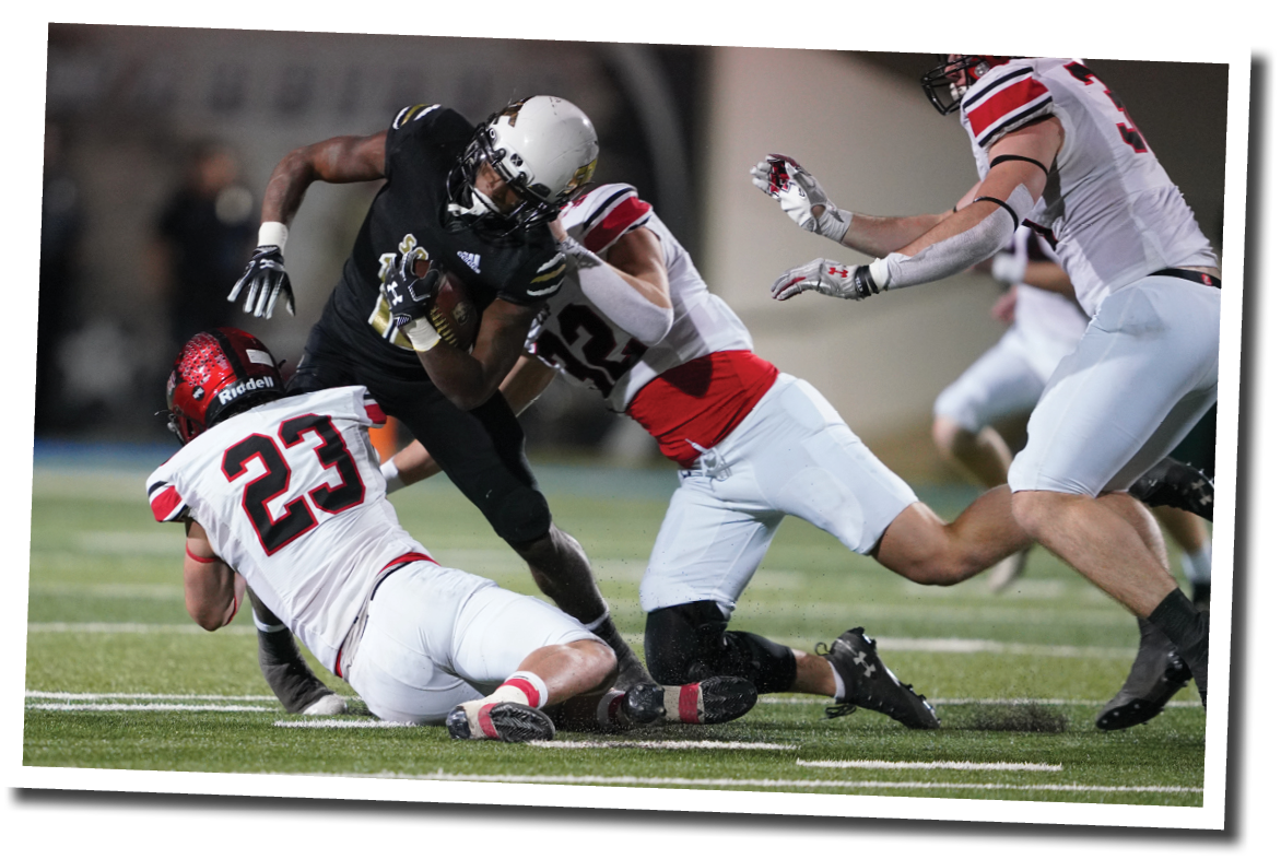 Kyle Lewis (23) and Tanner Menegay (32) tackle Ke undrae Hollywood  5A Division 2 State Semi-Final, Lubbock-Cooper vs  South Oak Cliff  Photo by: Aaron Baxter