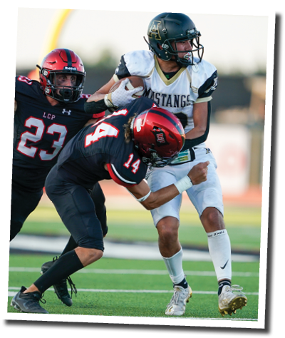 Koen Piepkorn (14) and Kyle Lewis (23) tackle Andrews WR Anthony Trevino (10)   Lubbock-Cooper vs  Andrews  Photo by: Aaron Baxter