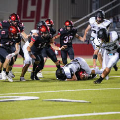 Pirate and Mustang players scramble for a loose ball on a short kickoff  Lubbock-Cooper vs  Andrews  Photo by: Aaron Baxter