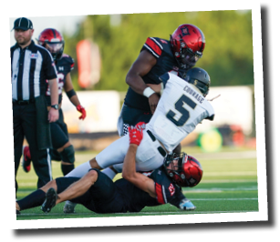 Callan Ritz (27) and Kobie McKinzie (2) take down Andrews QB EJ Lopez (5)  Lubbock-Cooper vs  Andrews  Photo by: Aaron Baxter