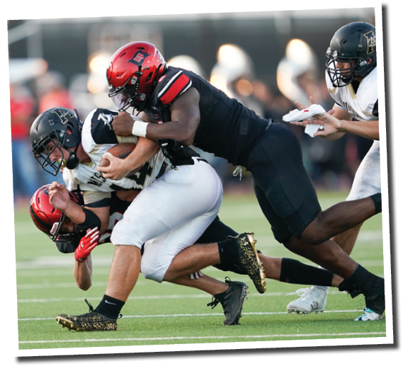 Callan Ritz (27) and Kobie McKinzie (2) tackle Mustang RB Jaxon Lawdermilk (44)  Lubbock-Cooper vs  Andrews  Photo by: Aaron Baxter