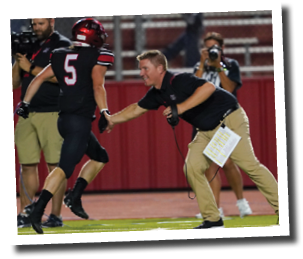Head coach Chip Darden congratulates his offense as they come off the field  Lubbock-Cooper vs  Andrews  Photo by: Aaron Baxter