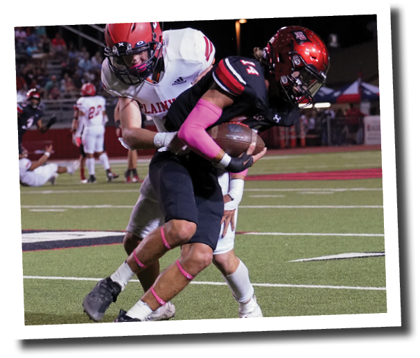 Koen Piepkorn (14) hauls in an interception and tries to shake a tackle  Lubbock-Cooper vs  Plainview  Photo by: Aaron Baxter