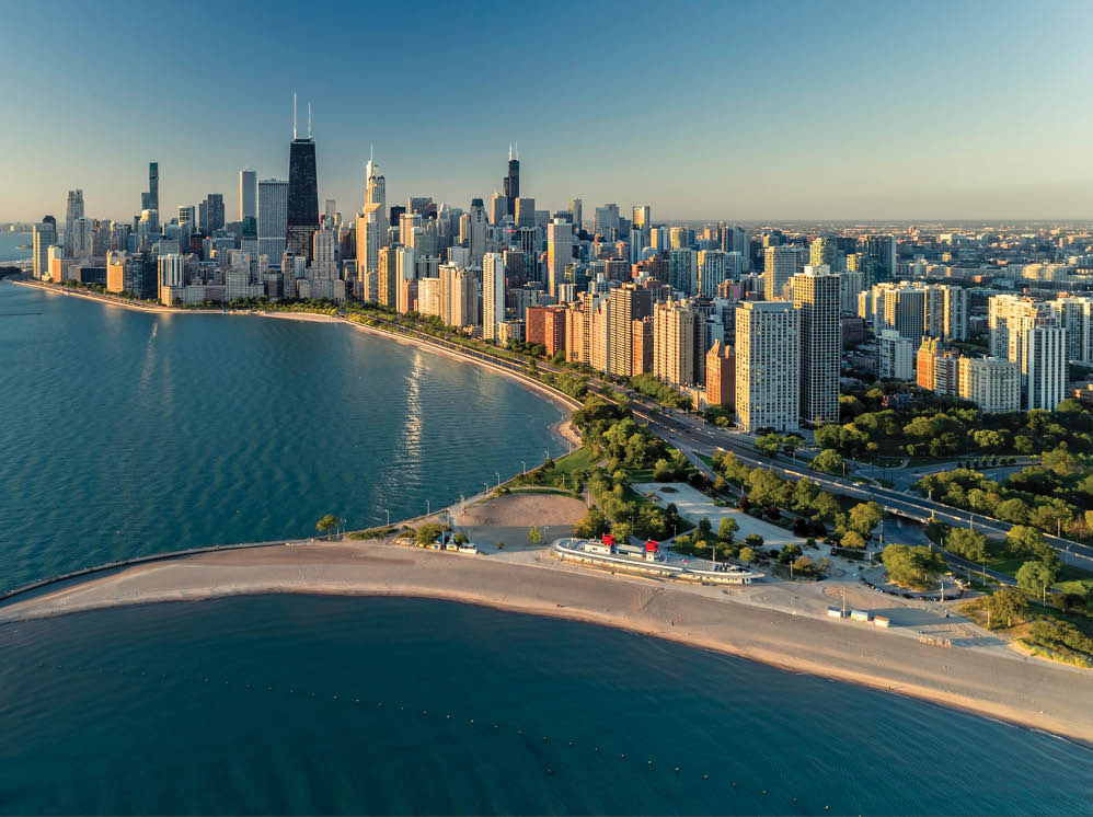 Aerial view of Chicago downtown skyline with park and the beach. Morning light with clear blue sky