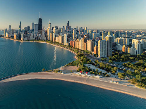 Aerial view of Chicago downtown skyline with park and the beach. Morning light with clear blue sky