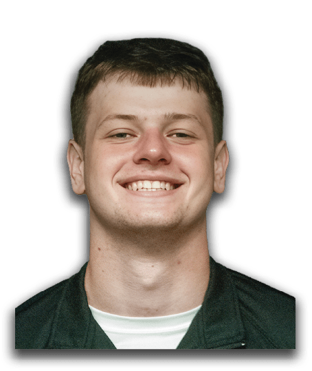 A man wearing a black shirt with a football logo on it is smiling. AI generated content