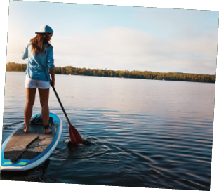 Shot of a young woman paddle boarding on a lake